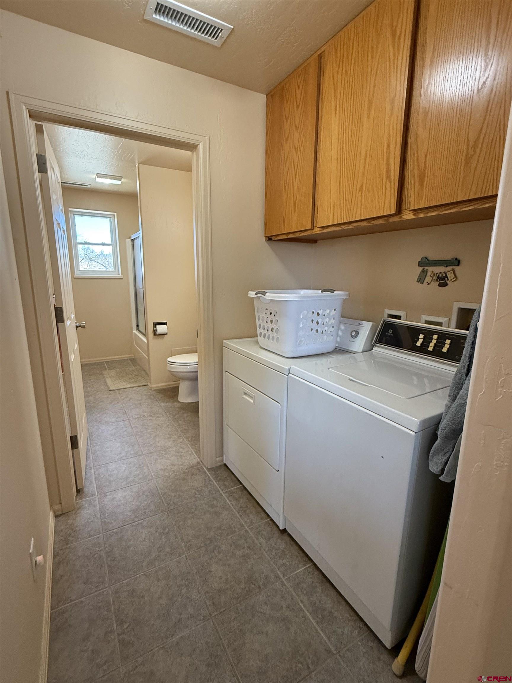9940 2150th Road Austin, CO 81410 - Photo 8 of 44 a view of storage and utility room with washer and dryer