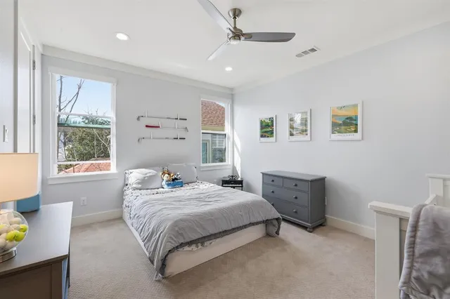 a bedroom with a bed dresser and window