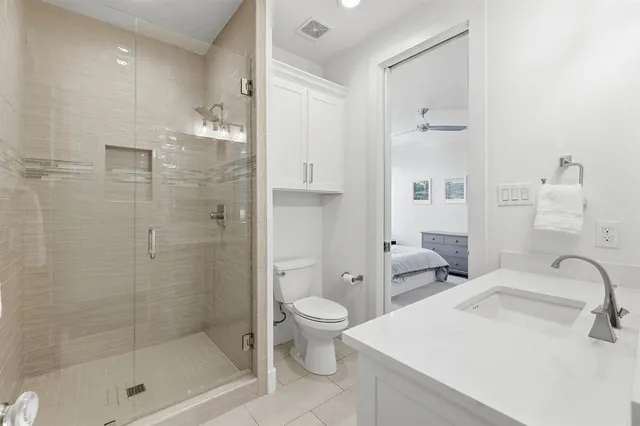 a bathroom with a sink toilet and shower