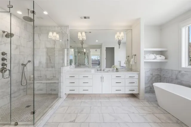a bathroom with a double vanity sink shower and a mirror