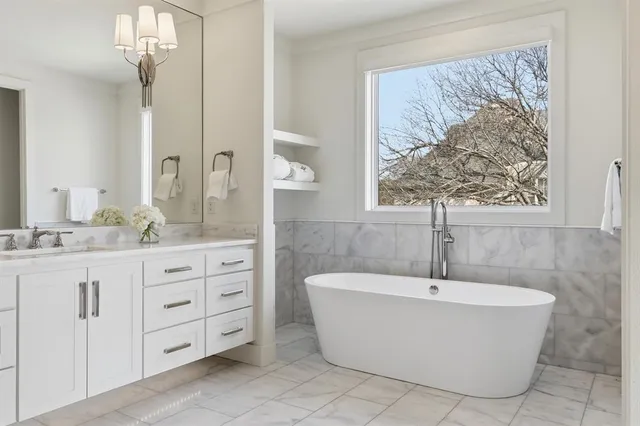 a bathroom with a bathtub and a large mirror