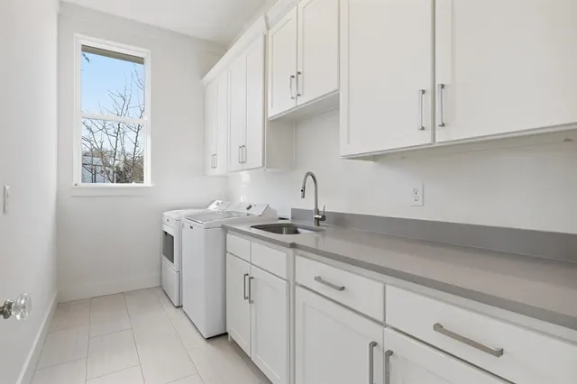 a kitchen with white cabinets and a sink