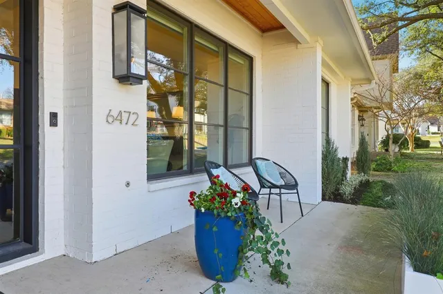 a front view of a house with outdoor seating and barbeque oven