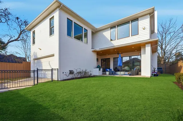 a view of a house with a yard and sitting area