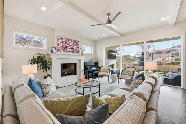 a living room with furniture ceiling fan and a fireplace
