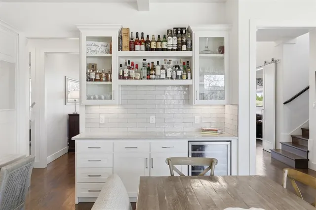 a kitchen with stainless steel appliances kitchen island granite countertop a refrigerator and wooden cabinets
