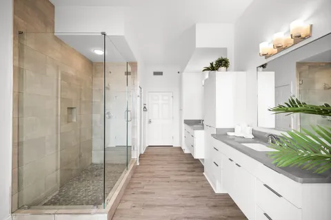 a bathroom with a shower and a glass door