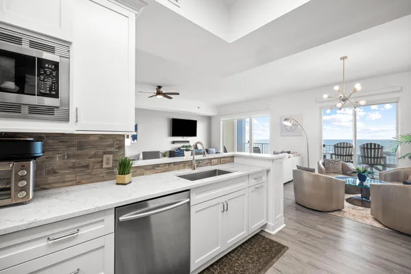 a kitchen with a sink and a stove top oven