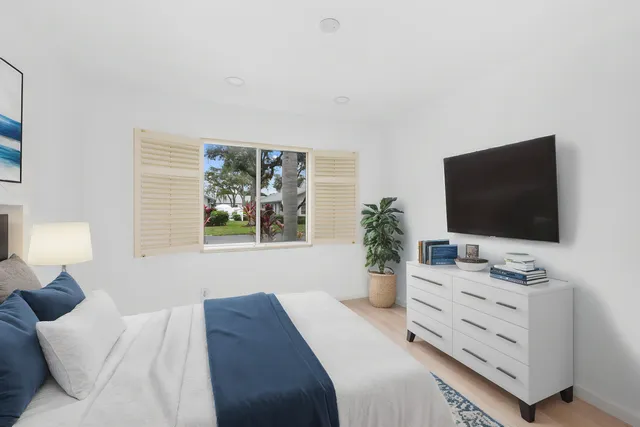a bedroom with a bed and a flat screen tv