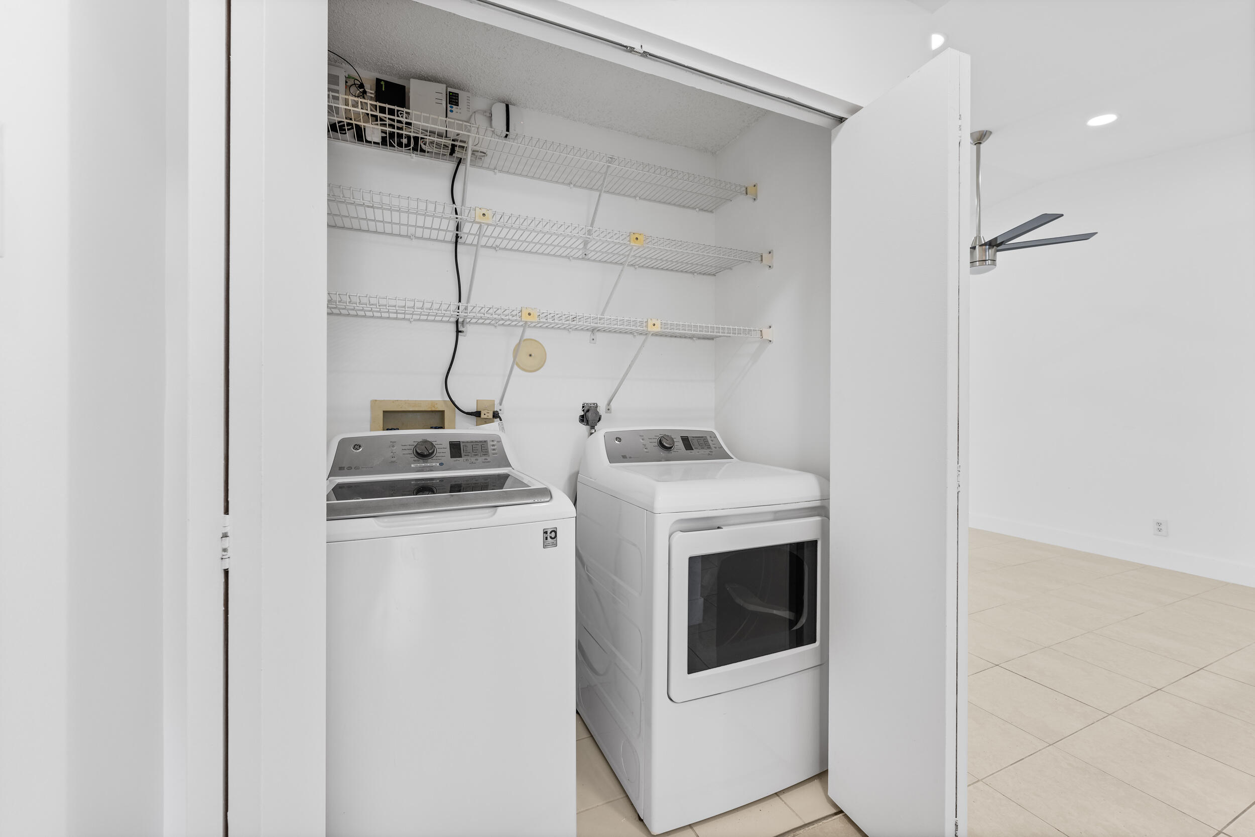 8888 Sunscape Lane Boca Raton, FL 33496 - Photo 26 of 35 a view of a storage & utility room with washer and dryer
