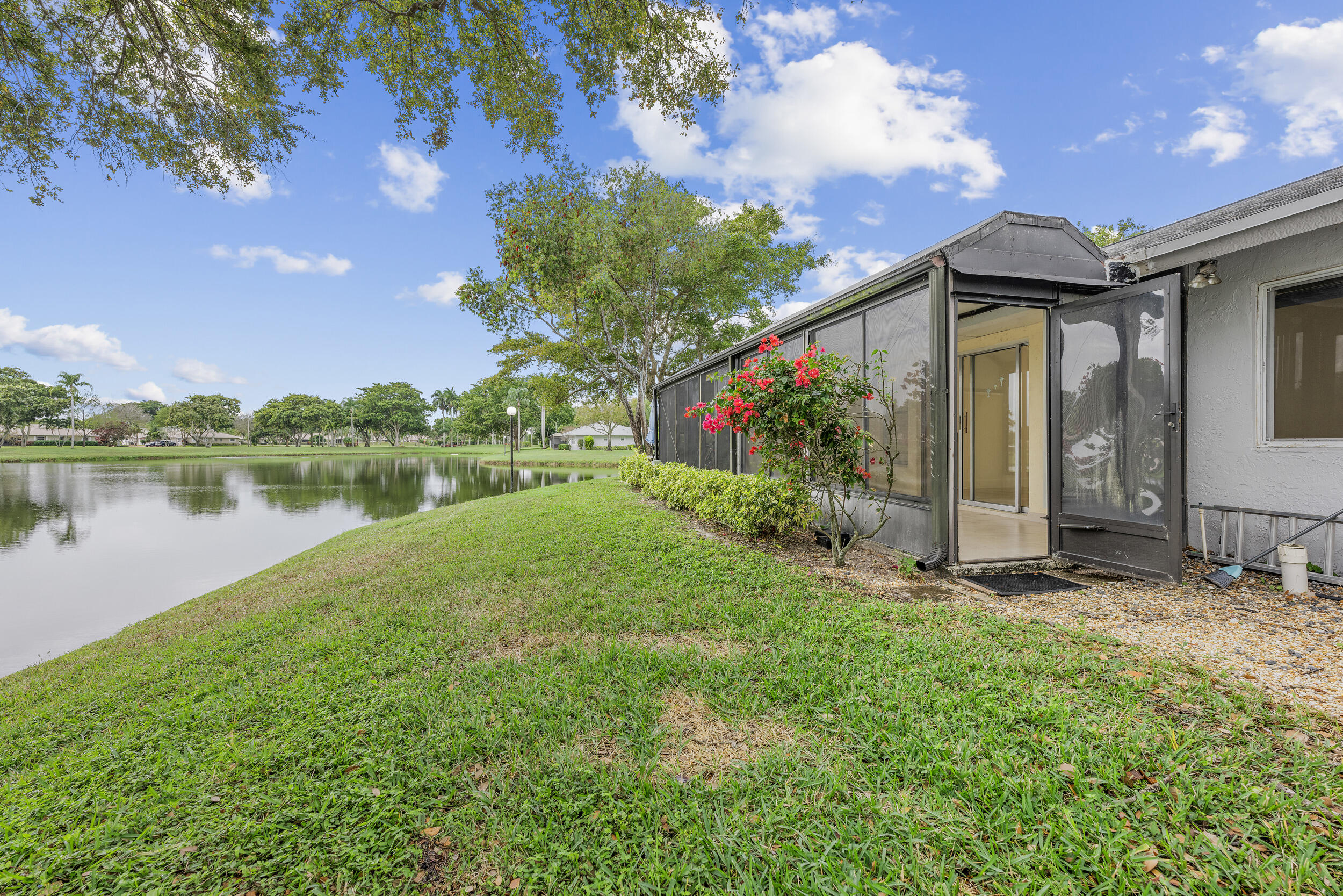 8888 Sunscape Lane Boca Raton, FL 33496 - Photo 27 of 35 a view of a house with a yard and a fountain