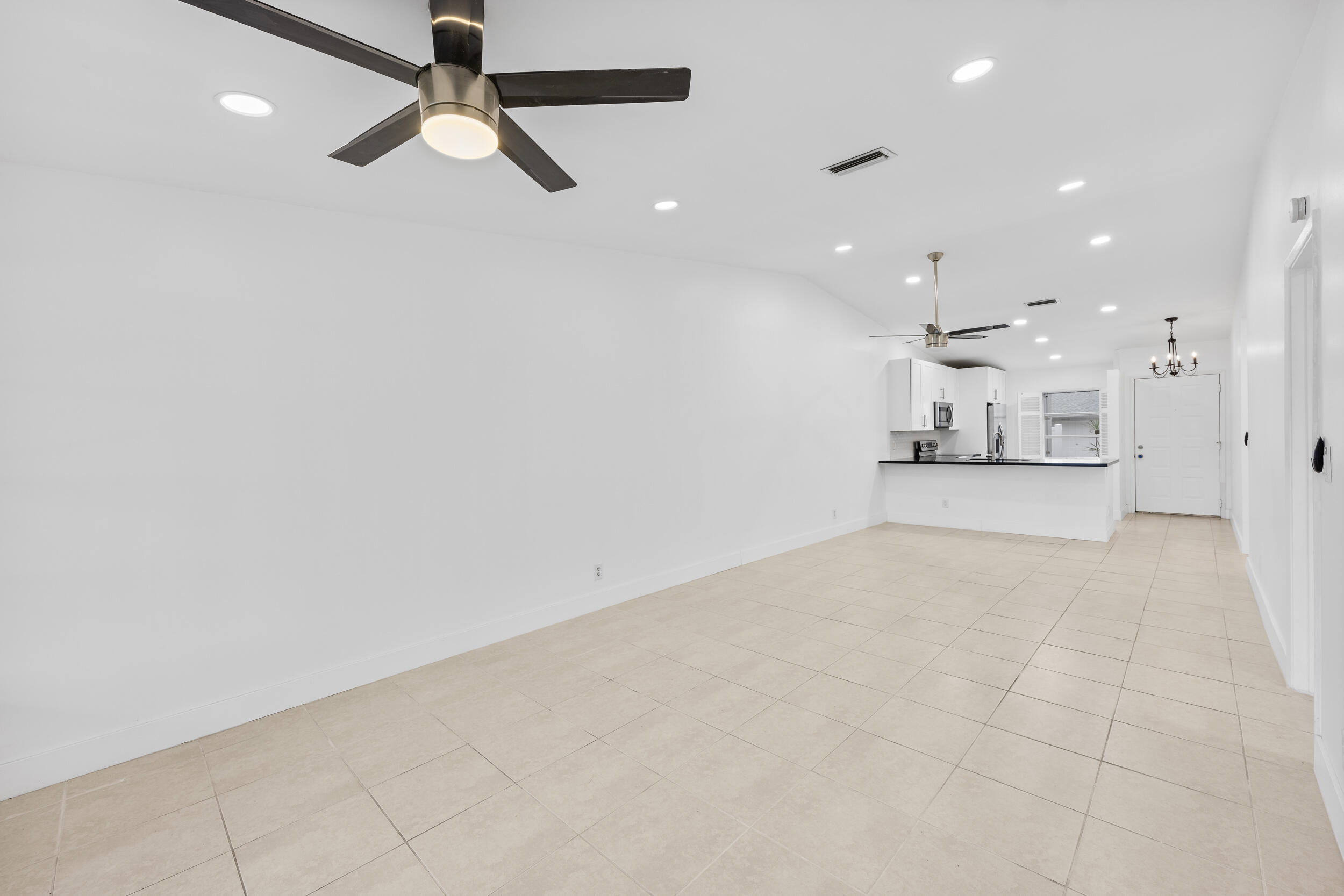 8888 Sunscape Lane Boca Raton, FL 33496 - Photo 7 of 35 a view of a kitchen with a sink and a refrigerator