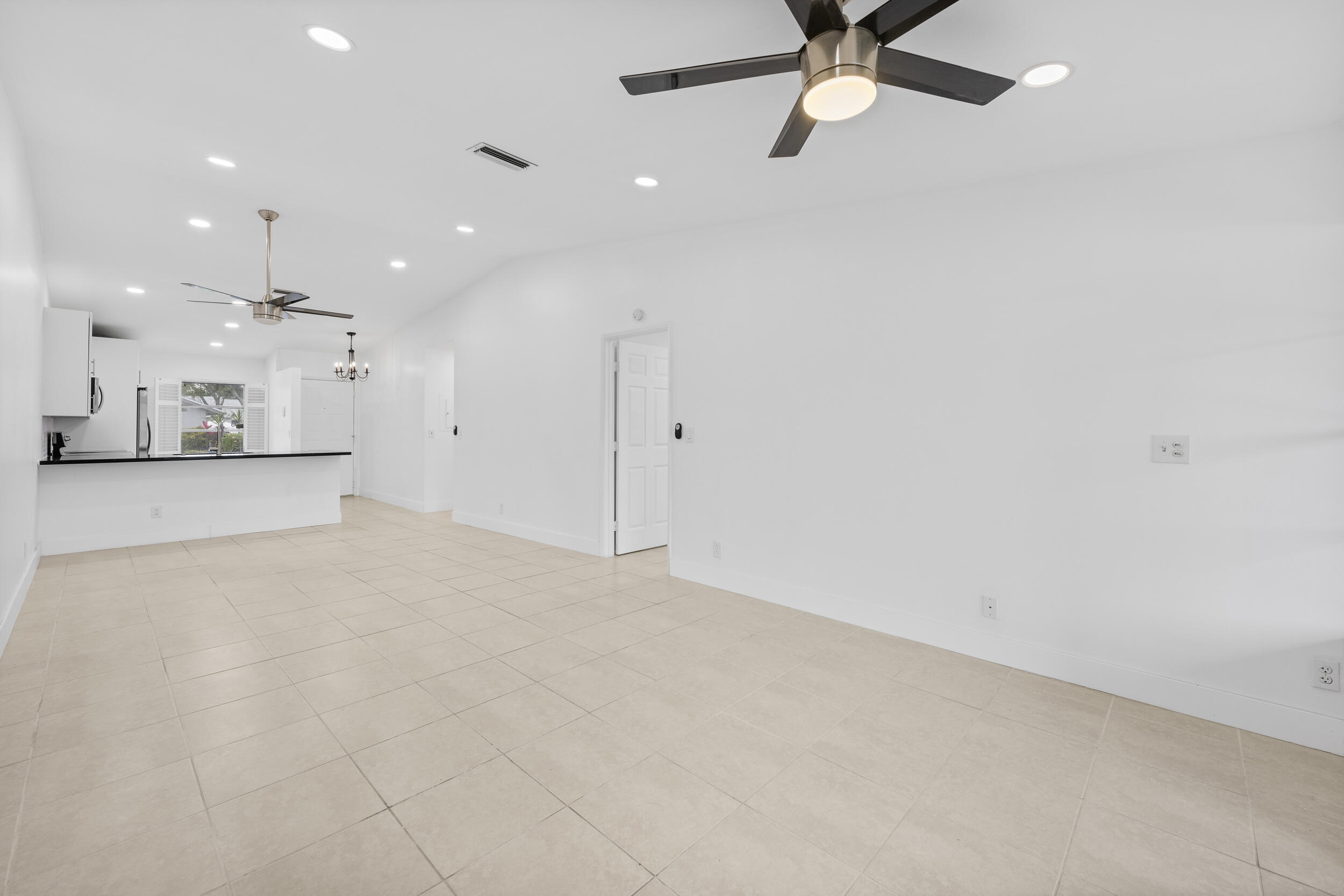 8888 Sunscape Lane Boca Raton, FL 33496 - Photo 9 of 35 an empty room with a ceiling fan and a window