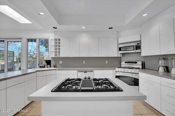 a kitchen with a stove a sink and a microwave