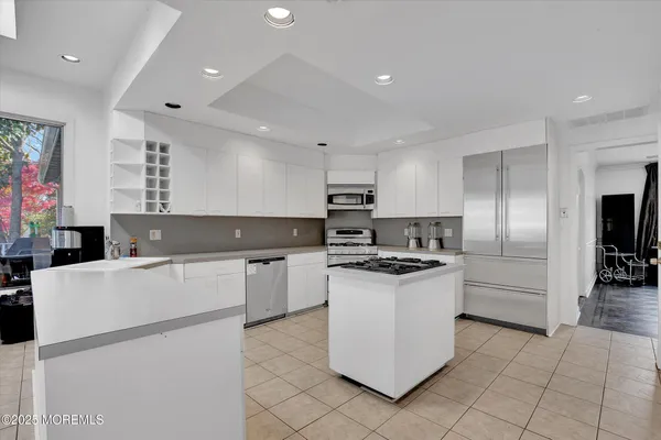 a kitchen with cabinets and white stainless steel appliances