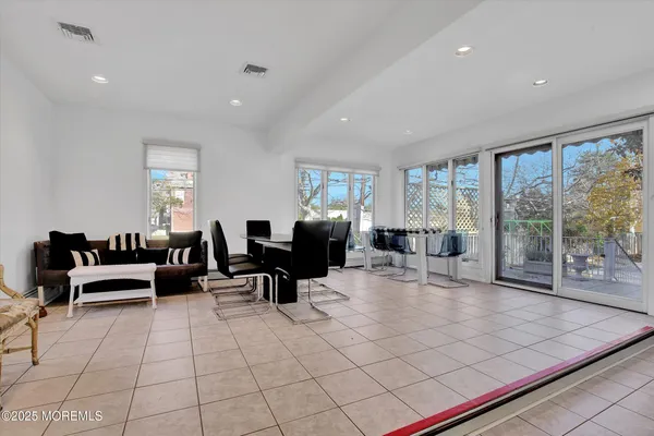 a living room with furniture and large windows