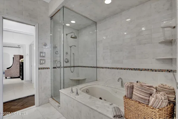 a bathroom with a bathtub and a shower