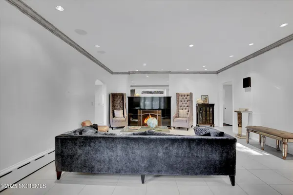 a living room with fireplace furniture and a large window