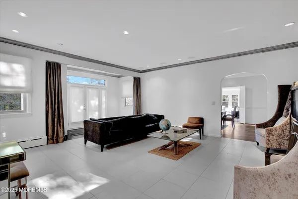 a living room with furniture gym equipment and a large window