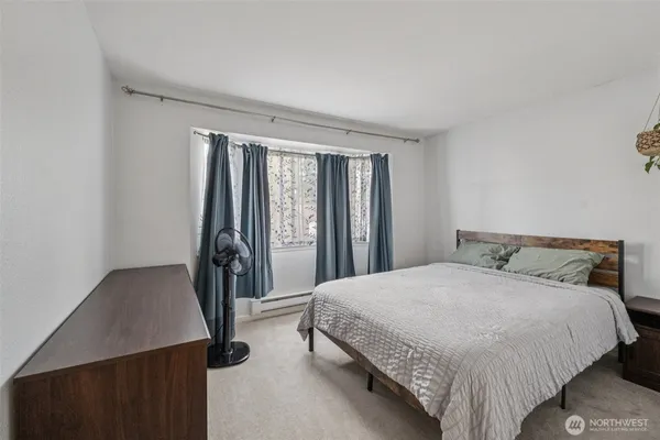 a bedroom with a bed and a window