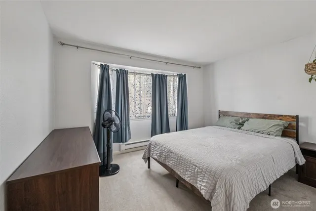 a bedroom with a bed and a window