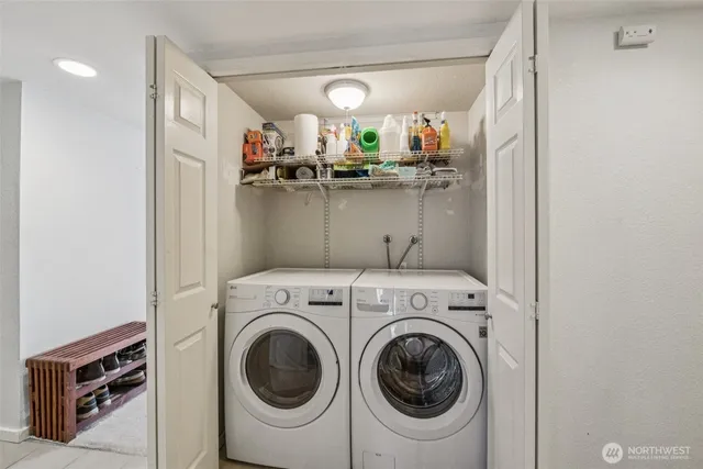 a view of a white house with a small yard and plants
