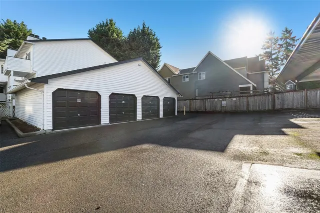 a view of a house with a yard and garage