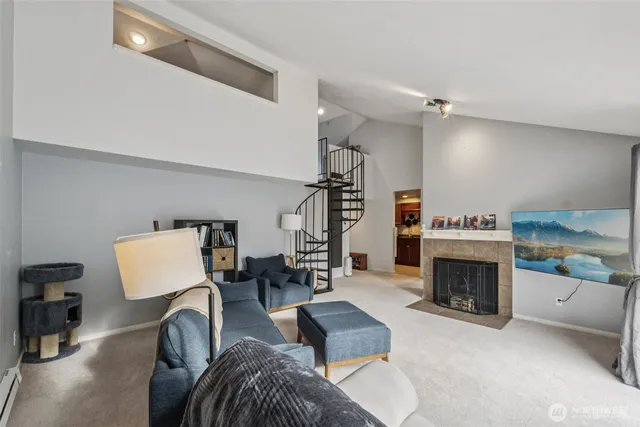 a living room with furniture a fireplace and a flat screen tv