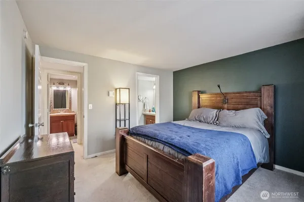 a large bed sitting in a bedroom and a table