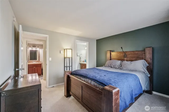 a large bed sitting in a bedroom and a table