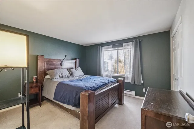 a bed sitting in a bedroom next to a window