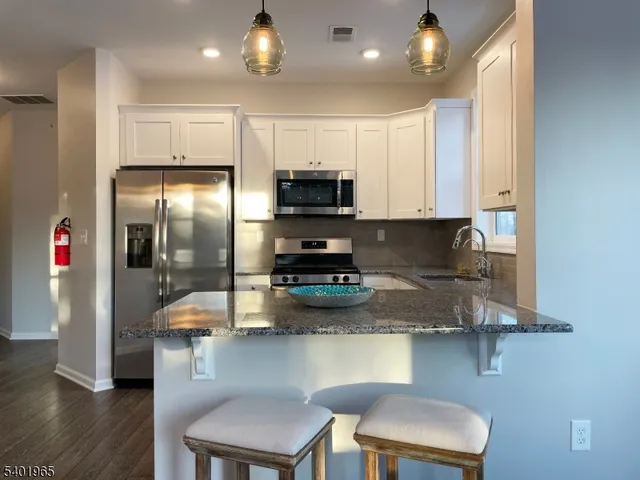a kitchen with a sink and a stove top oven