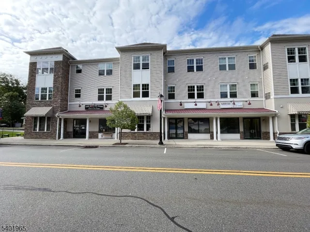 a view of building with cars parked