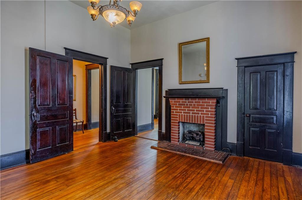 601 West 10th Street Rome, GA 30165 - Photo 15 of 25 an empty room with wooden floor fireplace and windows
