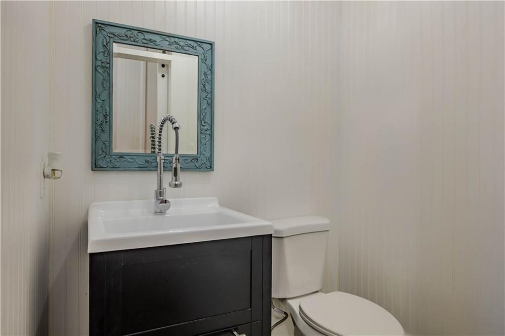 601 West 10th Street Rome, GA 30165 - Photo 20 of 25 a bathroom with a toilet a sink and mirror