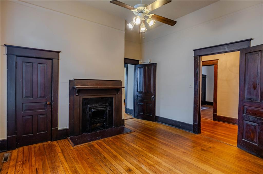 601 West 10th Street Rome, GA 30165 - Photo 5 of 25 a bedroom with a bed and wooden floor