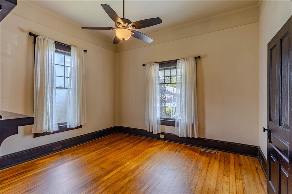 601 West 10th Street Rome, GA 30165 - Photo 6 of 25 an empty room with wooden floor and windows