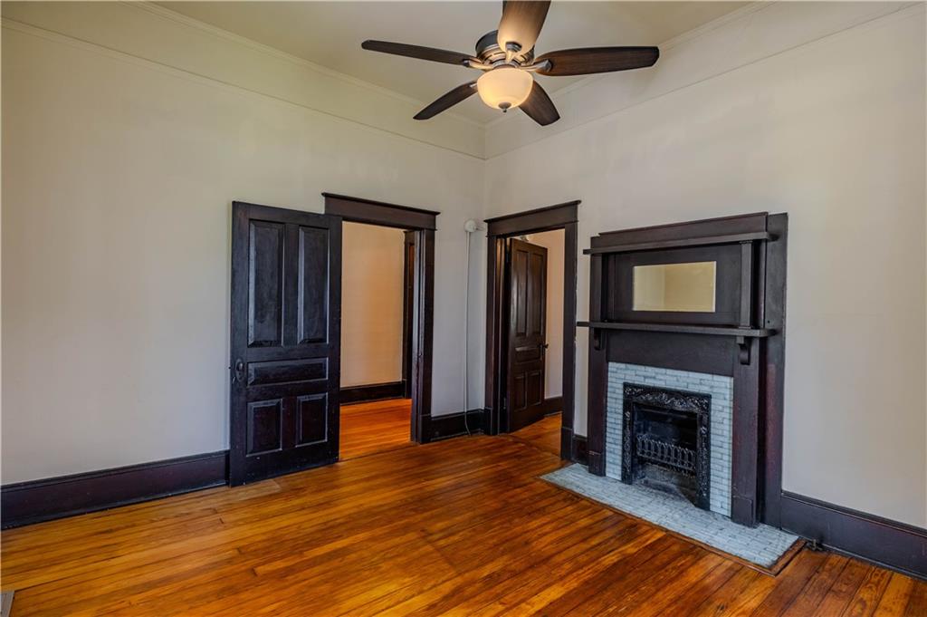 601 West 10th Street Rome, GA 30165 - Photo 7 of 25 a view of an empty room with wooden floor fireplace and a window