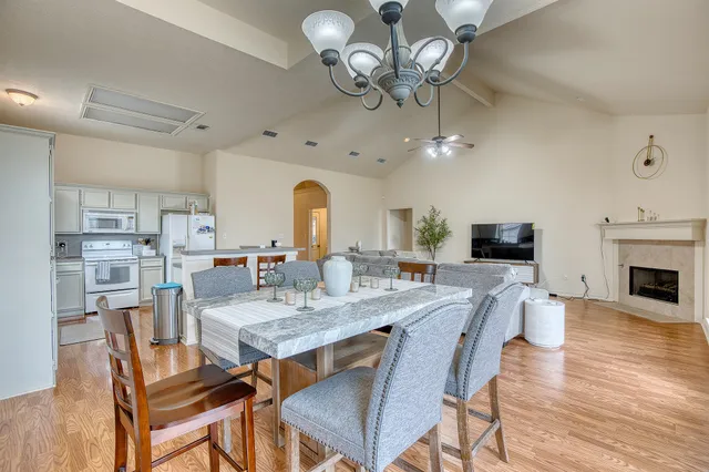 a view of a dining room with furniture wooden floor and chandelier
