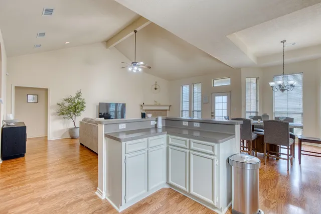 a spacious bedroom with a bed and a chandelier