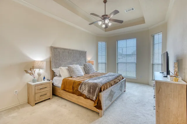 a bedroom with a bed and a night stand