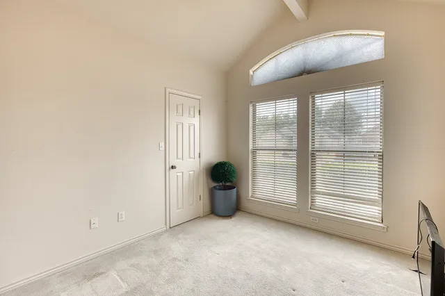 a view of a livingroom with wooden floor and a flat screen tv