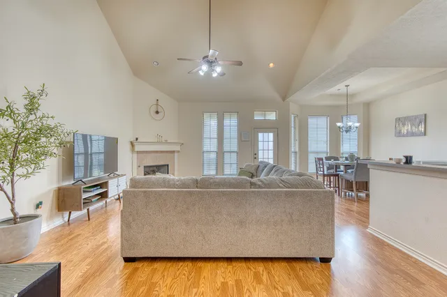 a living room with furniture and a chandelier