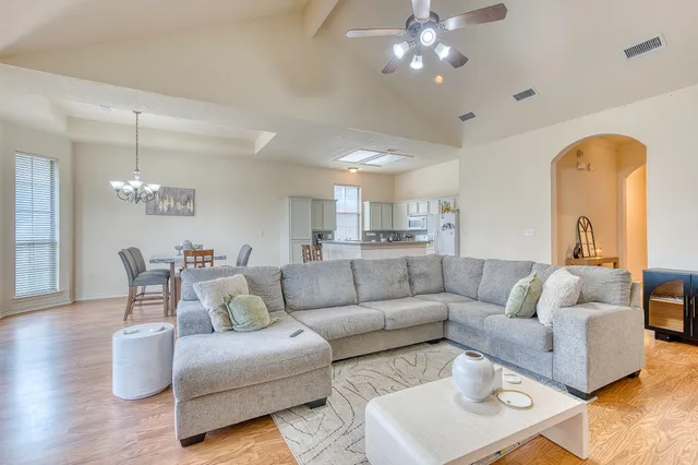 a living room with furniture and a chandelier
