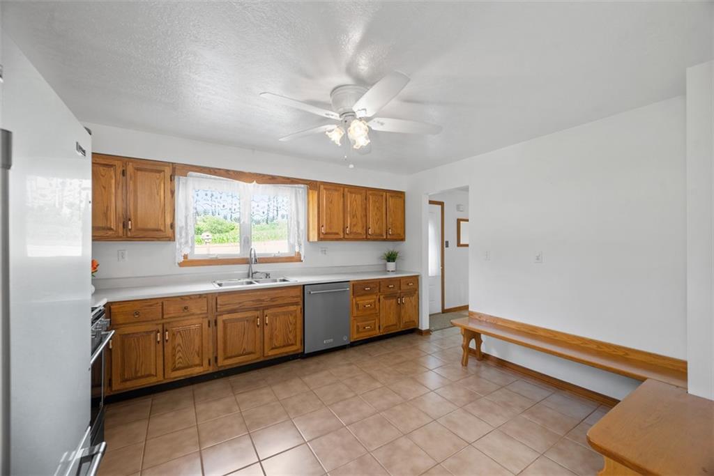 2812 Ridge Rd Extension Baden, PA 15005 - Photo 12 of 44 a large kitchen with granite countertop a stove a sink and dishwasher