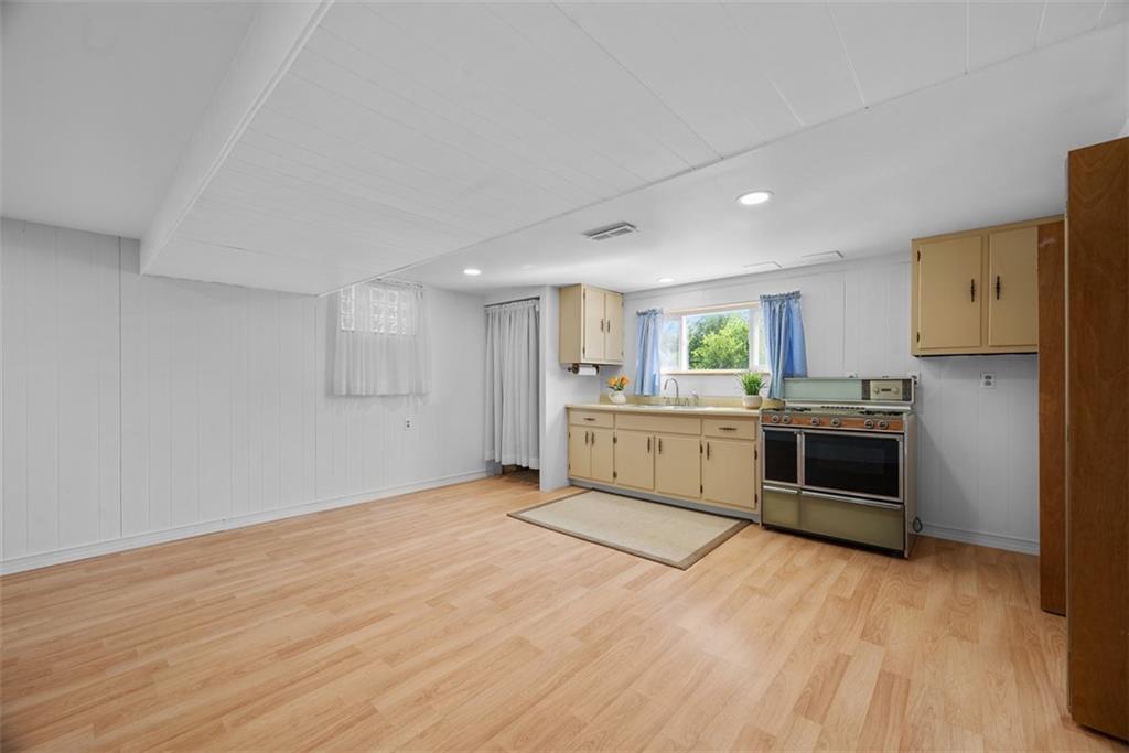 2812 Ridge Rd Extension Baden, PA 15005 - Photo 32 of 44 a large white kitchen with a stove top oven and sink