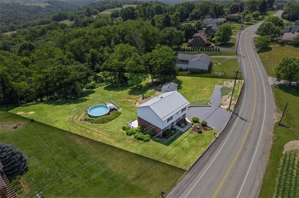 2812 Ridge Rd Extension Baden, PA 15005 - Photo 43 of 44 an aerial view of a house with swimming pool a yard and mountain view