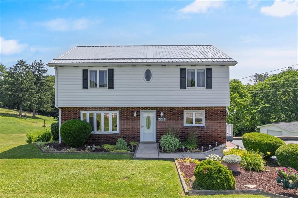 2812 Ridge Rd Extension Baden, PA 15005 - Photo 5 of 44 a front view of a house with a yard