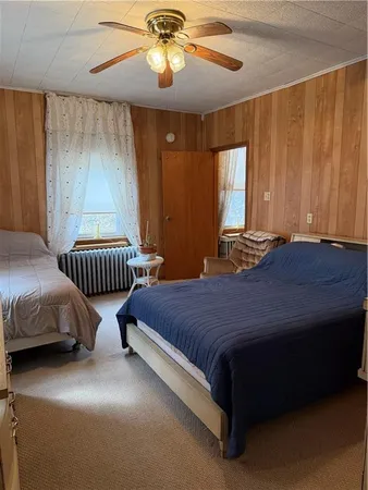 a bedroom with a bed and a wall painting