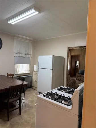 a open kitchen with stainless steel appliances granite countertop a stove refrigerator and cabinets